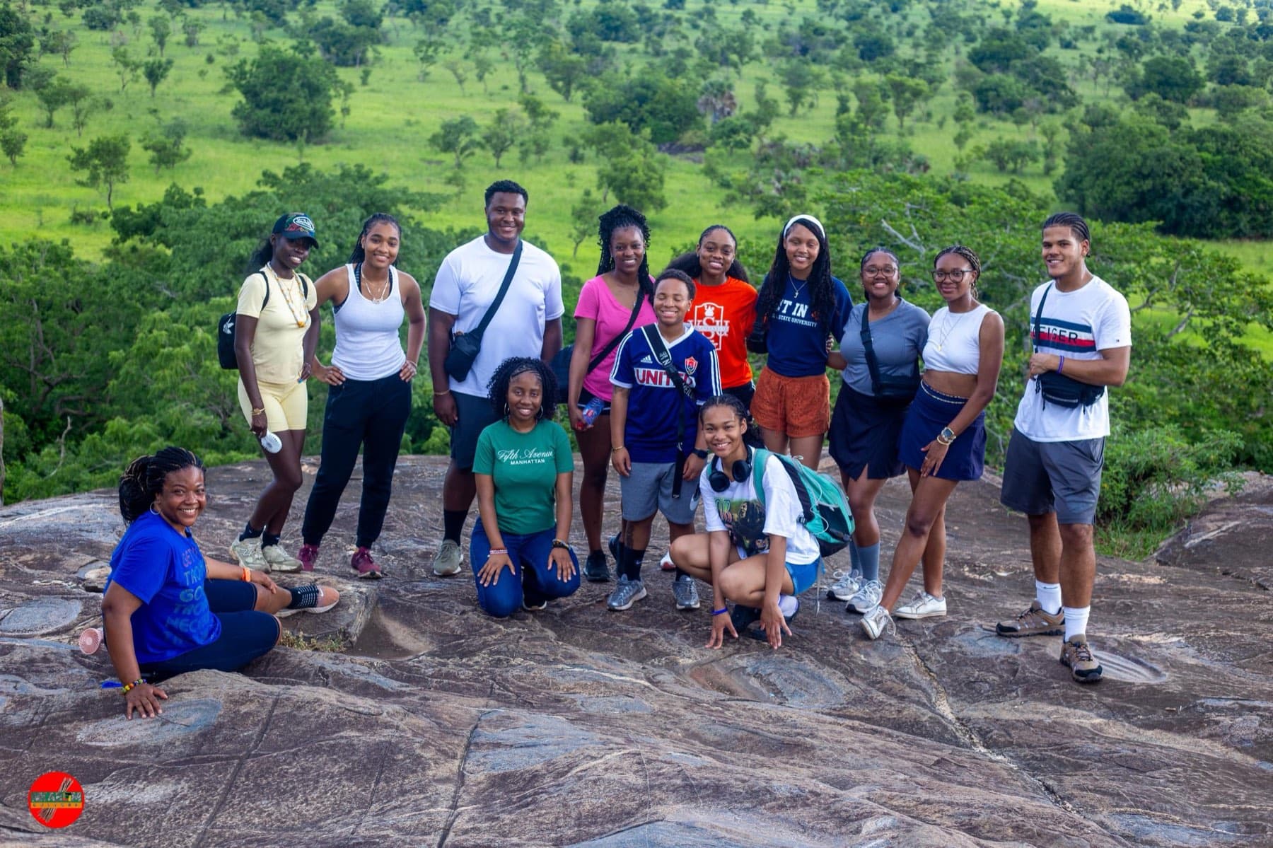 A student cohort on a granite outcrop above the Ghanaian savanna